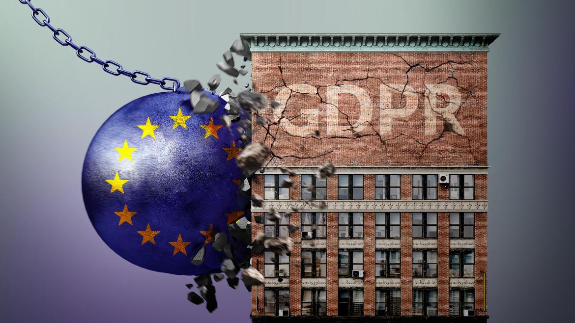Kula z unijną flagą wyburzająca budynek z napisem GDPR